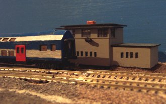 Das frühere Stellwerk W3 des Bahnhofs Großräschen am Abzwg. Sonne mit Modell vom DR-Standard-Sitzwagen aus den 70ern